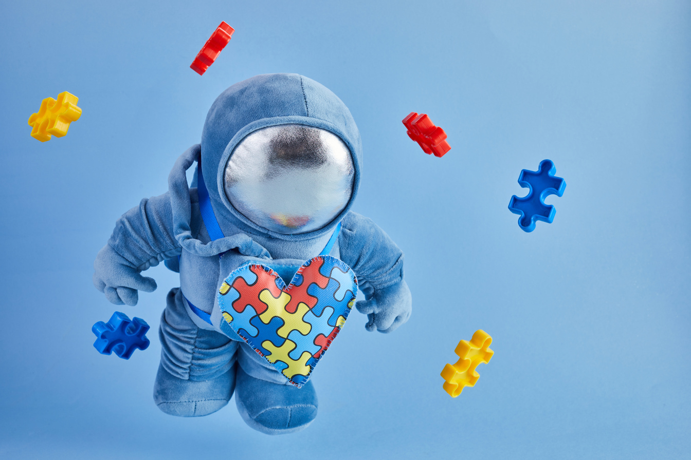 Toy Astronaut and Puzzle Pieces 